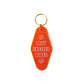 Is Muy Excited Vibes Motel Keychain in Orange